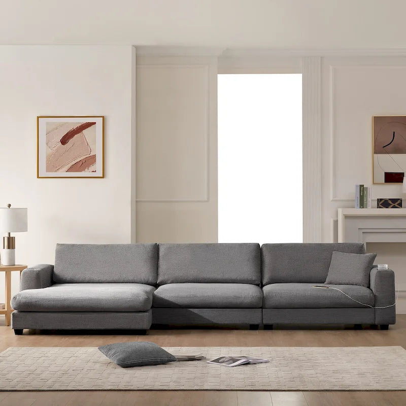 Divano componibile a L in velluto a coste grigio con chaise longue, portabicchieri e porte USB, 3-4 posti a sedere